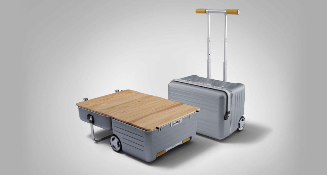 Side-front view of orange Grandi10 with lakeside view at night