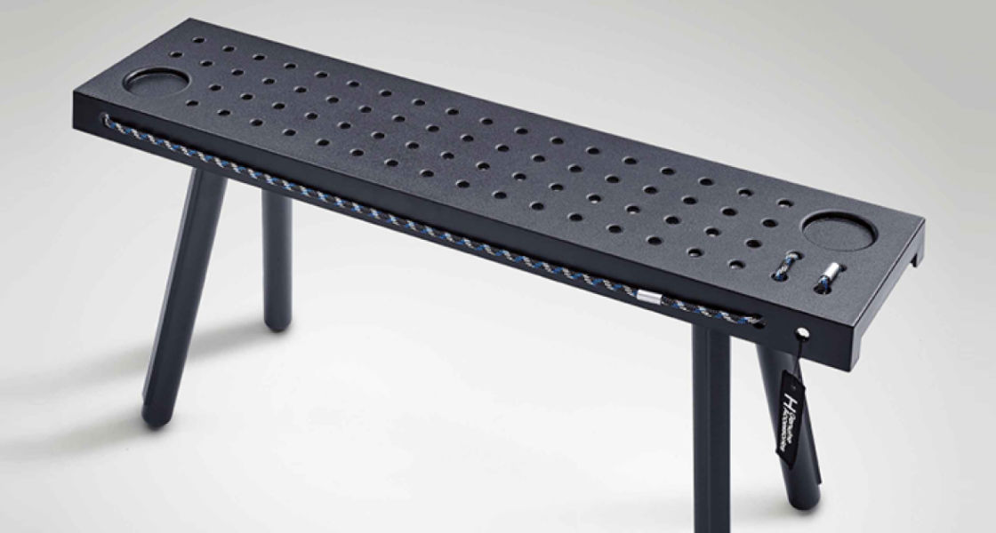 Side-front view of orange Grandi10 with lakeside view at night