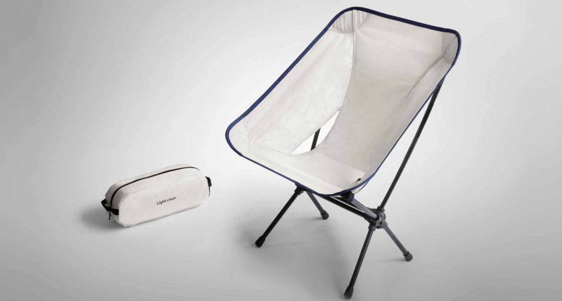 Side-front view of orange Grandi10 with lakeside view at night